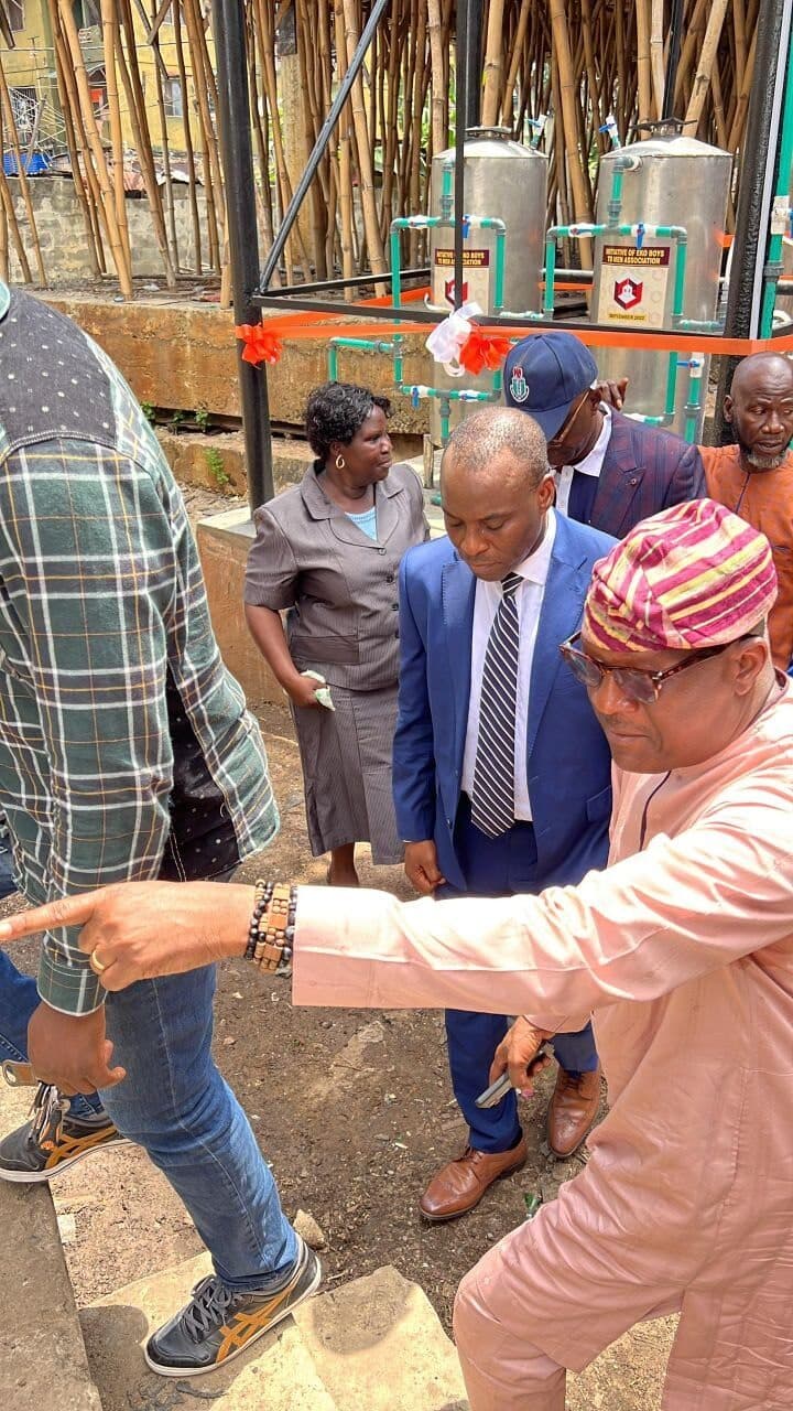 Eko Boys To Men members inspecting the installed water purification system during the commissioning